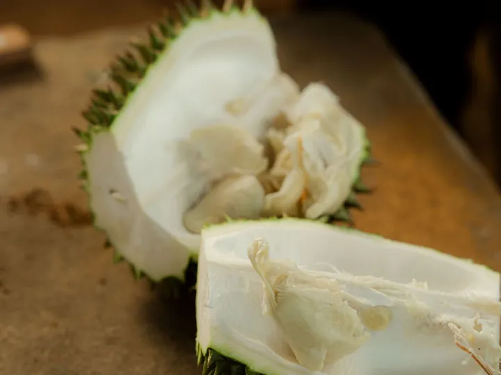 Freshly opened durian showing creamy pale yellow flesh