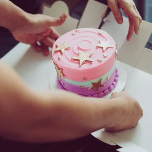 Pink star cake being placed into its box