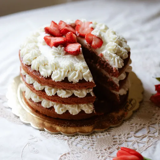Strawberry layer cake with a slice cut out