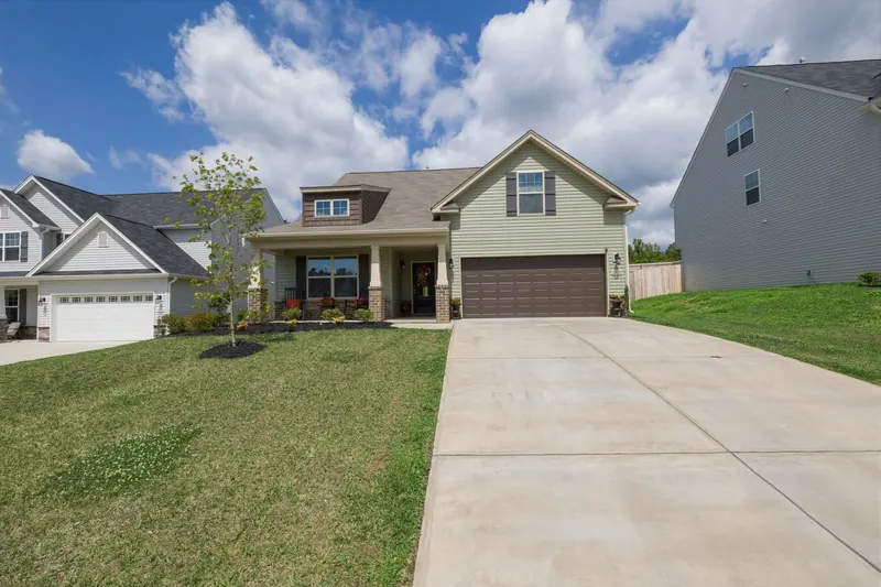 Concrete driveway in front of a two-story suburban house